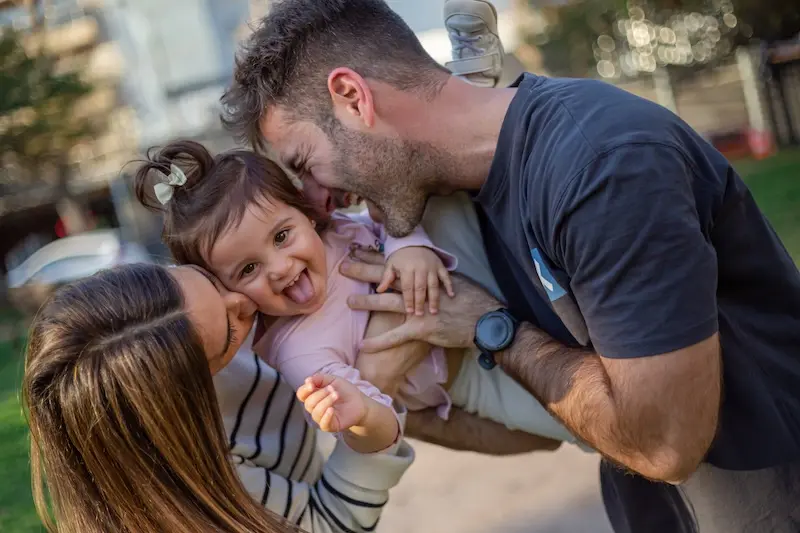 Fabricio, Fiorella, and their daughter Franca sharing a joyful moment at Parque Villa Biarritz in Montevideo